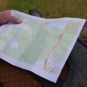 Determining Location with Cross-Bearing Adventure trip planned? Escape to nature! Check out those roads, green areas, and landmarks on your map. Grab your brown backpack and head out in your outdoor gear. Experience an unforgettable adventure!