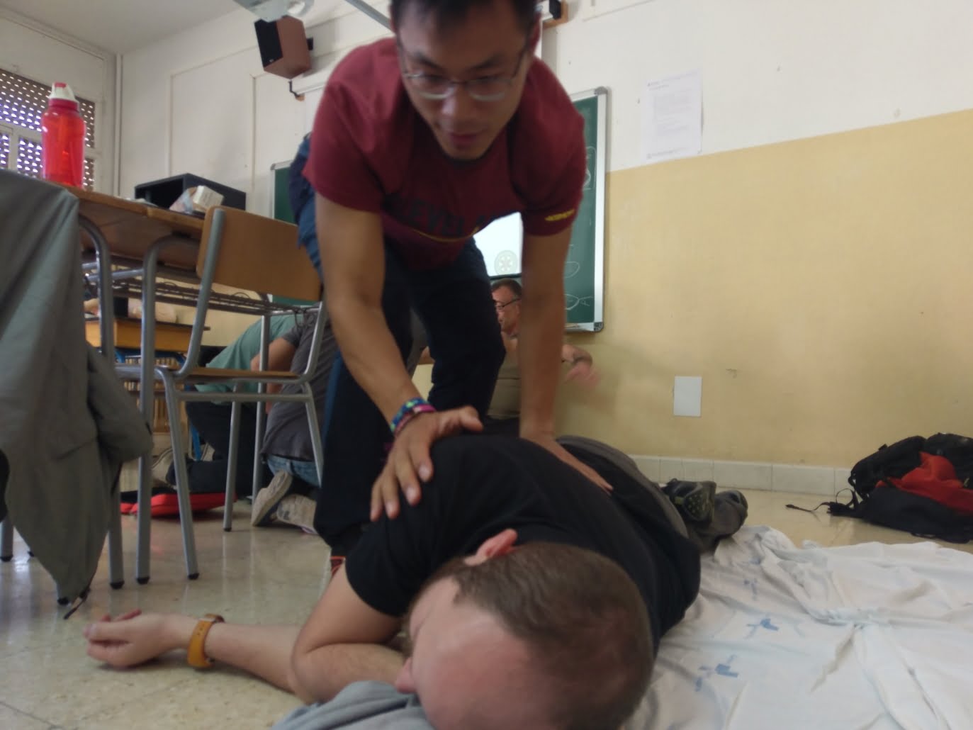 Performing Recovery Position on Patient Experience an adventurous first aid workshop in Utrecht! Learn life-saving techniques like the recovery position in an interactive, outdoor environment. Sign up now and be part of this challenging experience.