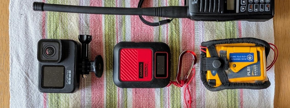 A table with a bunch of cell phones and other electronic devices.