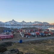 IMG-20260531-WA0000 View of an Arctic landscape with containers and mountains in the background.
